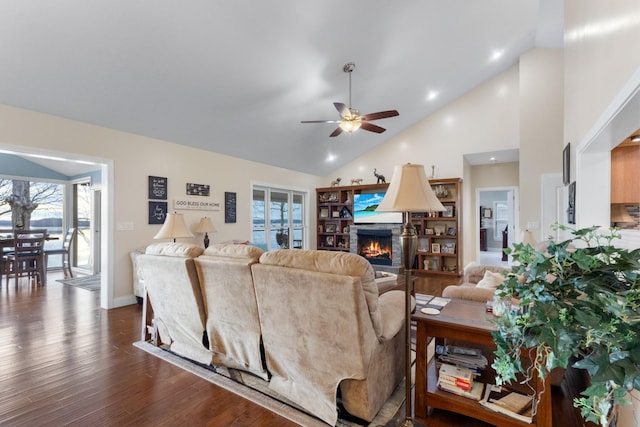 living room with ceiling fan, high vaulted ceiling, and dark hardwood / wood-style floors