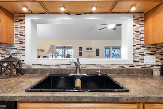 kitchen featuring decorative backsplash, sink, and a wealth of natural light