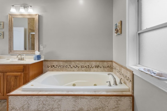 bathroom with vanity and tiled tub