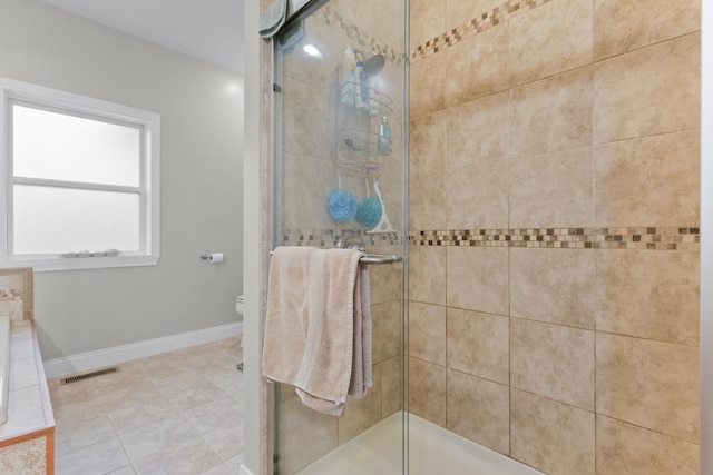 bathroom with toilet and an enclosed shower