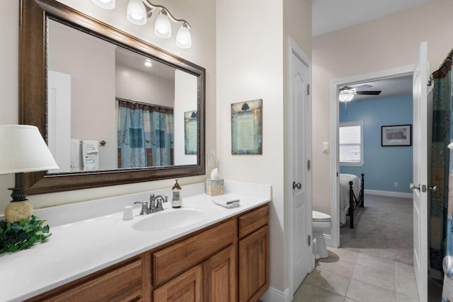 bathroom with tile patterned flooring, vanity, toilet, and ceiling fan