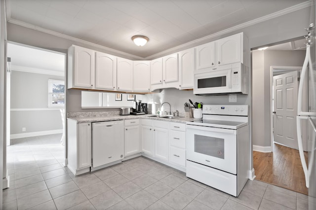 kitchen with white cabinetry, crown molding, light tile patterned flooring, and white appliances