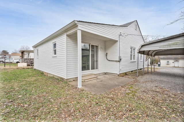 view of property exterior with a carport and a yard