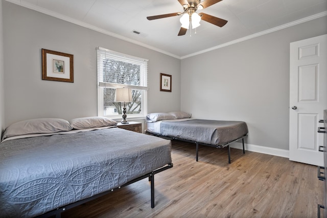 bedroom featuring light wood-type flooring, ceiling fan, and crown molding