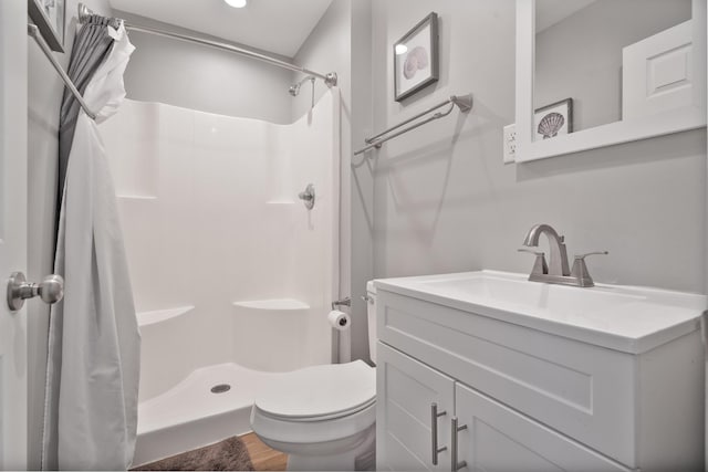 bathroom with vanity, toilet, and curtained shower