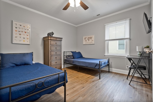 bedroom with hardwood / wood-style flooring, ceiling fan, and crown molding