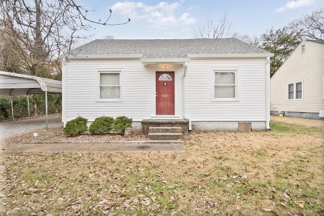 view of front of house with a front lawn and a carport