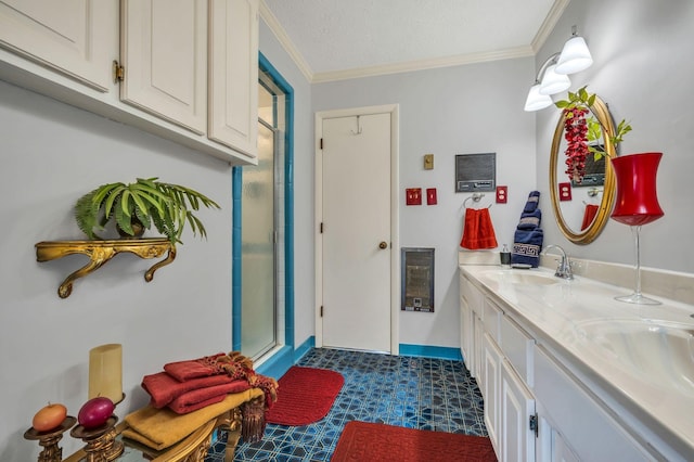 bathroom featuring ornamental molding, vanity, a textured ceiling, and a shower with shower door