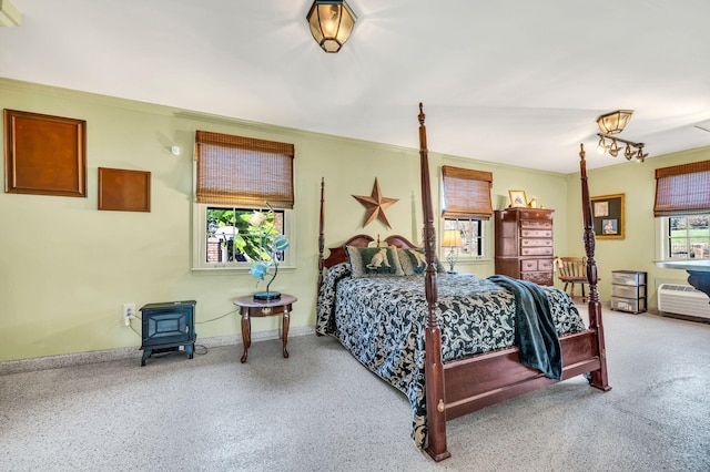 bedroom featuring carpet flooring and a wood stove