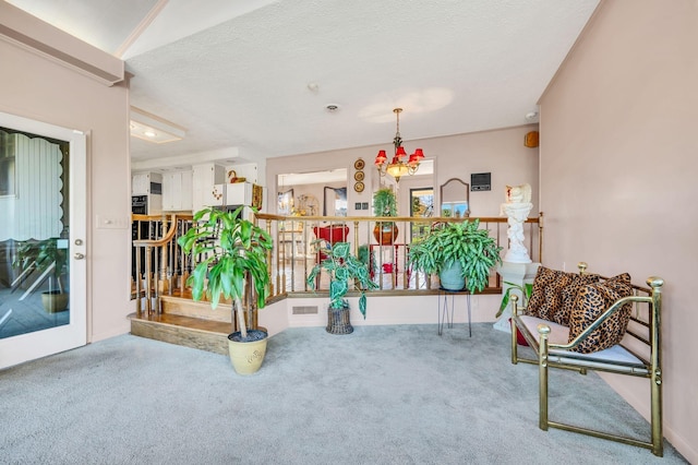 interior space featuring carpet floors, a chandelier, and a textured ceiling