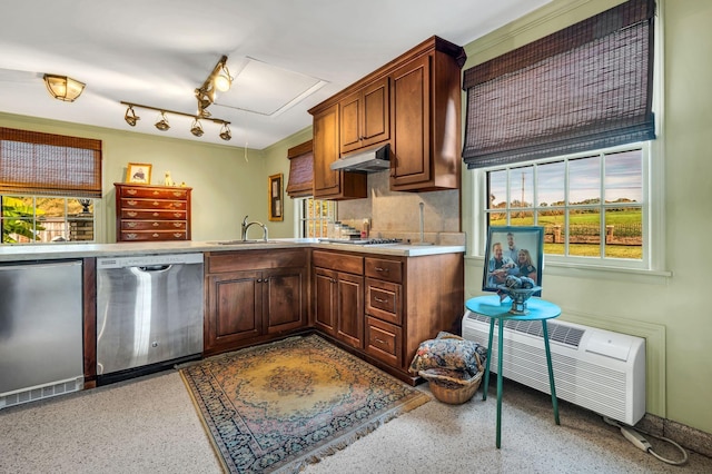 kitchen featuring a wall mounted air conditioner, sink, stainless steel appliances, and tasteful backsplash