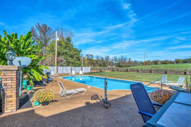 view of swimming pool with a lawn and a patio