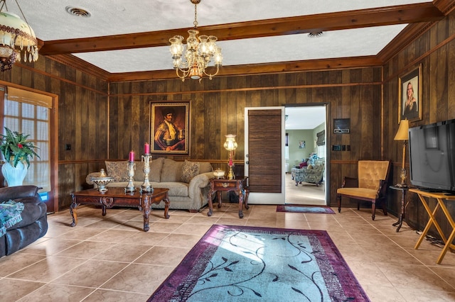 tiled living room with beam ceiling, wood walls, a textured ceiling, and a notable chandelier