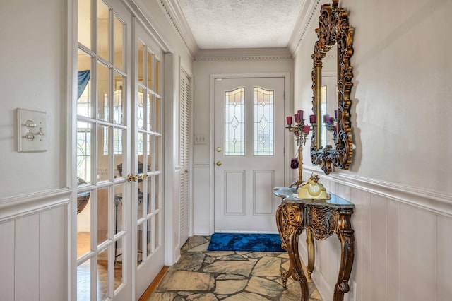 entryway featuring french doors and a textured ceiling