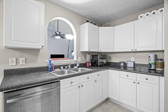 kitchen with dishwasher, sink, ceiling fan, a textured ceiling, and white cabinetry