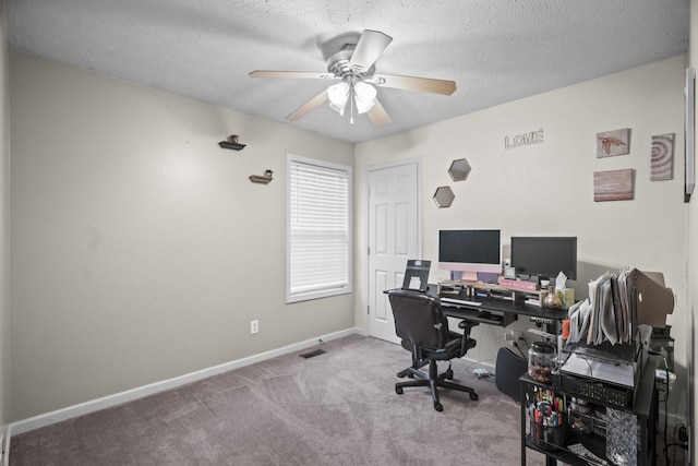 office with a textured ceiling, ceiling fan, and light carpet