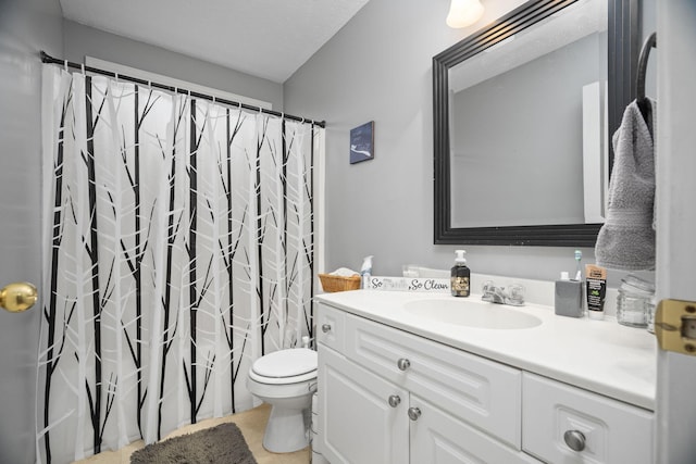 bathroom with walk in shower, vanity, and toilet