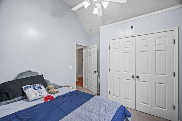 bedroom with ceiling fan, a closet, light colored carpet, and lofted ceiling