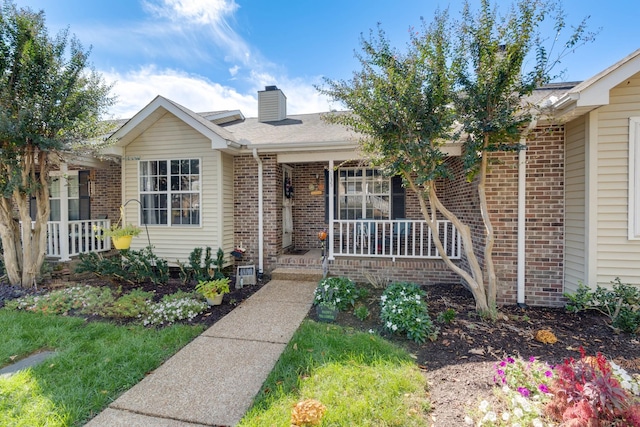 property entrance with covered porch