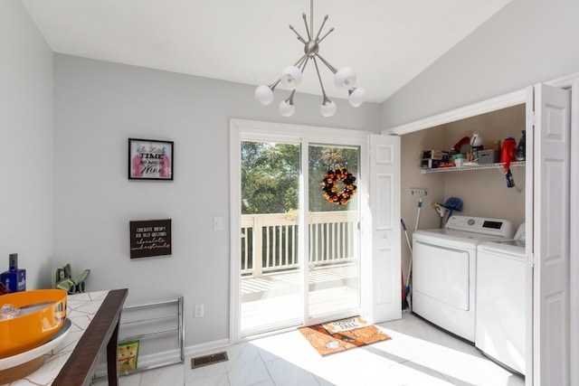 laundry room featuring a chandelier, light tile patterned floors, and washing machine and dryer