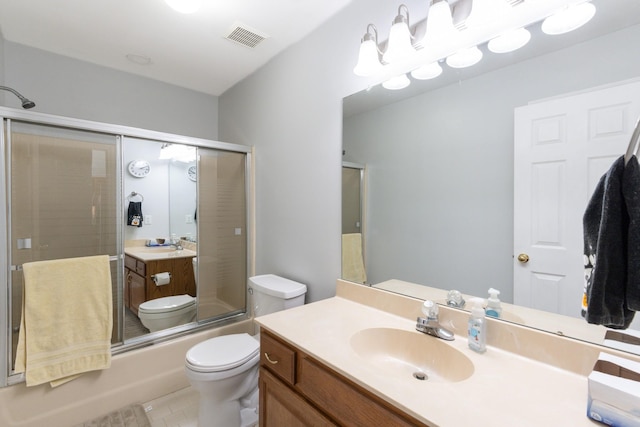 full bathroom featuring tile patterned floors, toilet, vanity, and combined bath / shower with glass door