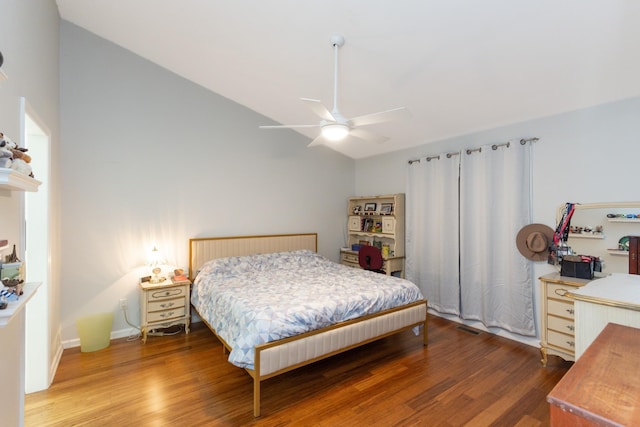 bedroom with hardwood / wood-style flooring, ceiling fan, and lofted ceiling