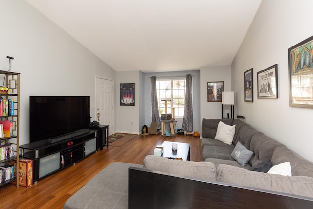 living room with wood-type flooring and lofted ceiling