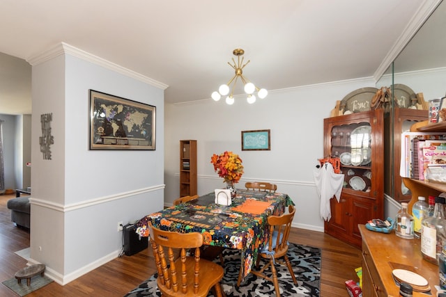 dining room featuring dark hardwood / wood-style floors, crown molding, and a chandelier