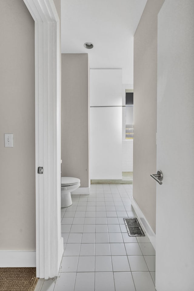 bathroom with tile patterned flooring and toilet