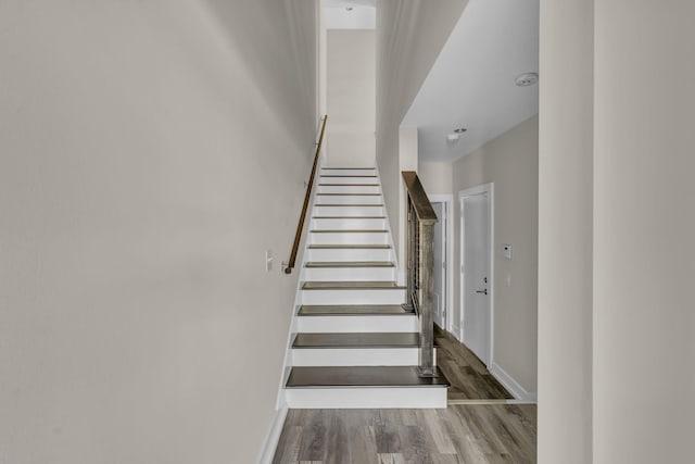 stairway with hardwood / wood-style flooring