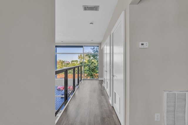 hallway featuring dark hardwood / wood-style floors, floor to ceiling windows, and french doors