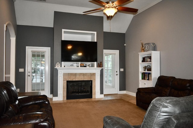 living room featuring ceiling fan, lofted ceiling, and a tiled fireplace