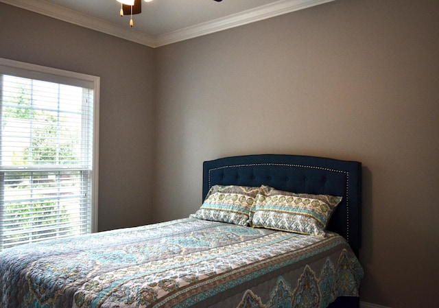 bedroom with multiple windows, ceiling fan, and crown molding