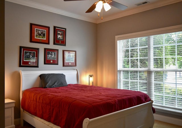 bedroom featuring multiple windows, carpet, ceiling fan, and ornamental molding