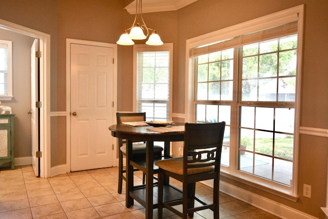 dining room with crown molding, light tile patterned floors, and a notable chandelier