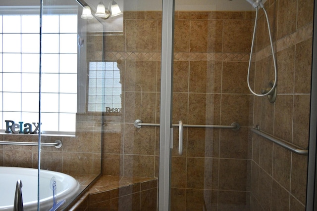 bathroom featuring shower with separate bathtub