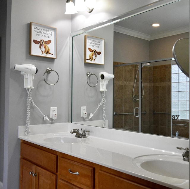 bathroom with tiled shower, vanity, and crown molding