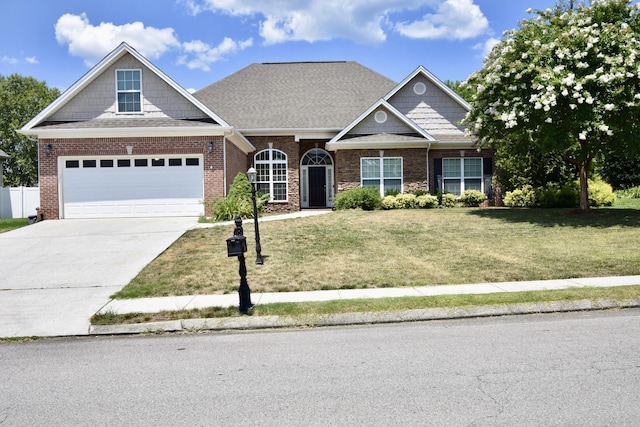 view of front of property featuring a front yard and a garage