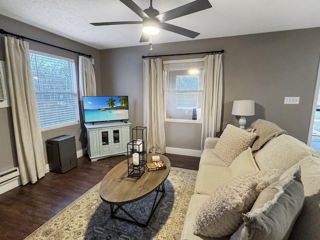 living room featuring ceiling fan and dark wood-type flooring