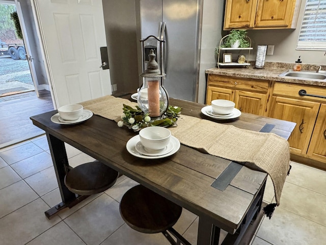 dining room with light tile patterned floors and sink