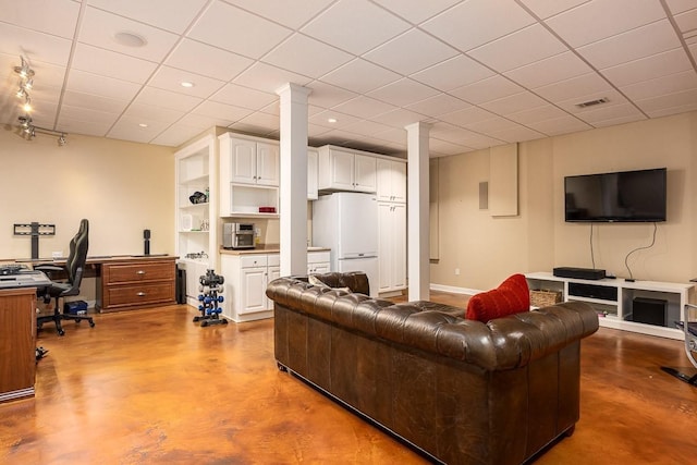 living room featuring a drop ceiling