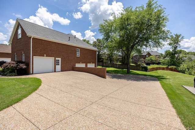 view of property exterior with a garage and a lawn