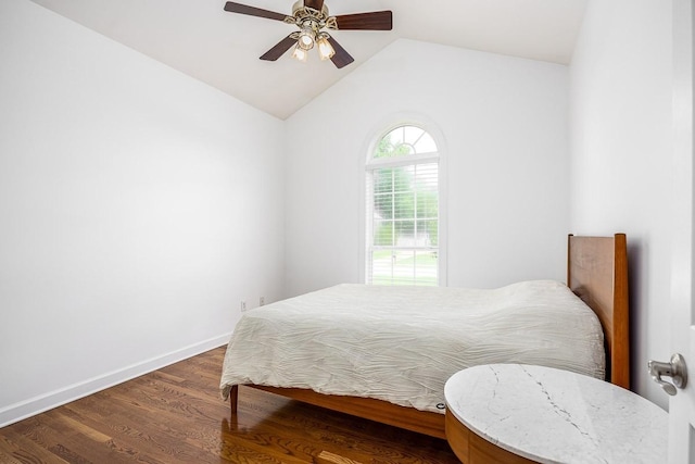 bedroom featuring ceiling fan, dark hardwood / wood-style flooring, and vaulted ceiling