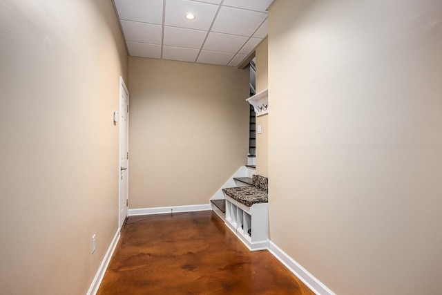 hallway with dark hardwood / wood-style flooring and a drop ceiling