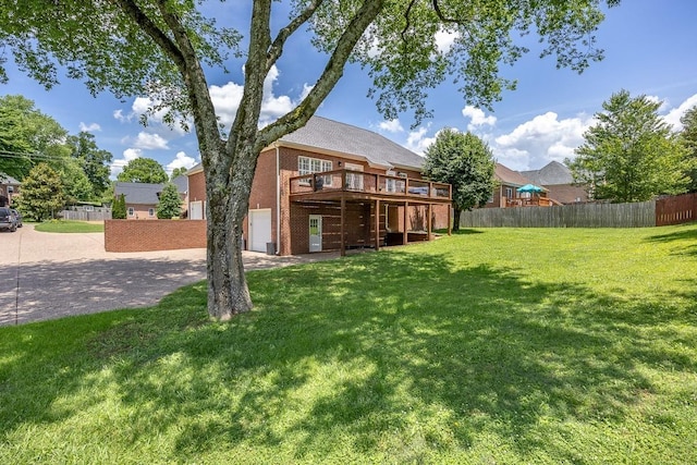 view of yard featuring a garage and a wooden deck