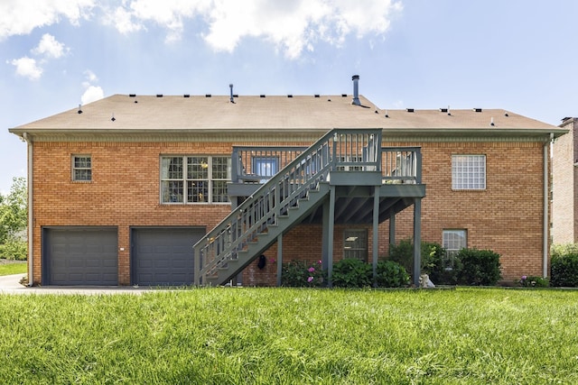 rear view of property featuring a garage, a wooden deck, and a yard