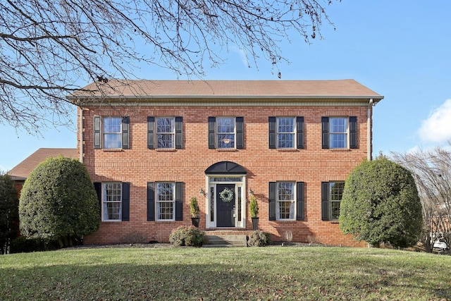 colonial-style house with a front lawn