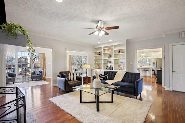 living room featuring ornamental molding, a textured ceiling, ceiling fan, and dark hardwood / wood-style flooring