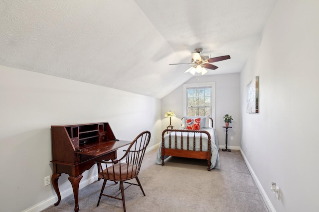 carpeted bedroom with ceiling fan and vaulted ceiling