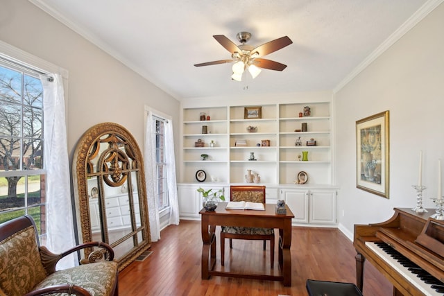 home office with dark hardwood / wood-style flooring, ceiling fan, and crown molding